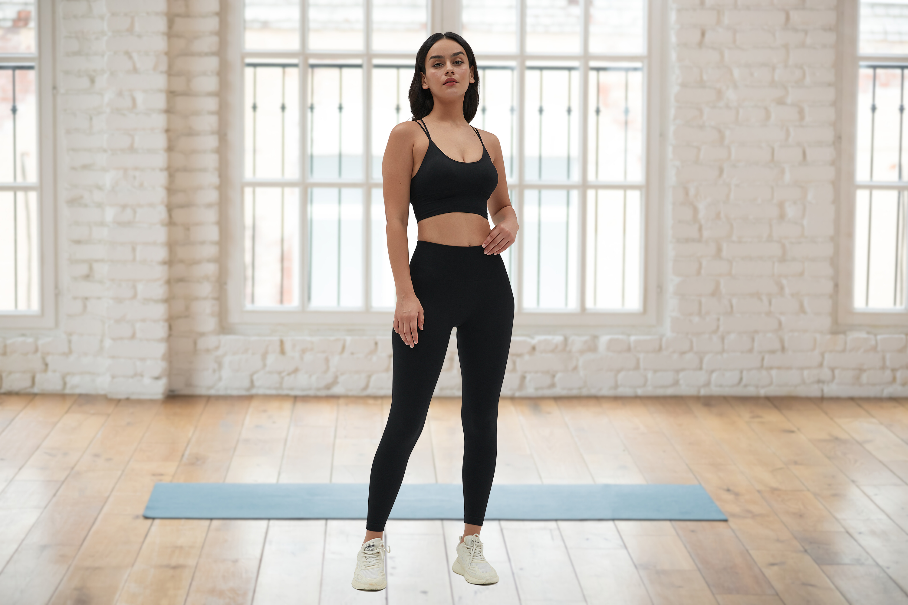 Amend Co. model wearing sustainable black sports bra and black leggings