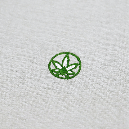 A close up photo of the Amend Co. embroidered logo on gray organic cotton and organic hemp sustainable fabric