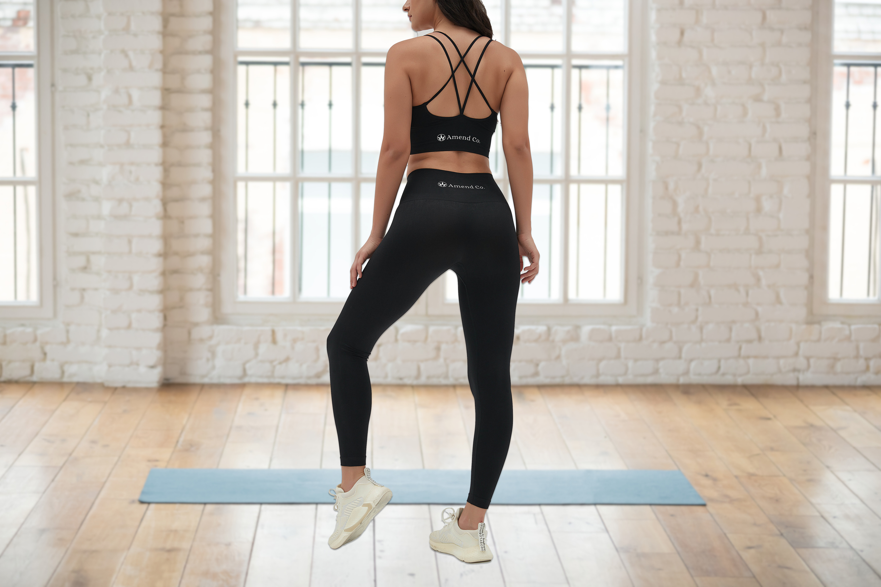 Amend Co. model wearing eco-friendly black sports bra and black leggings