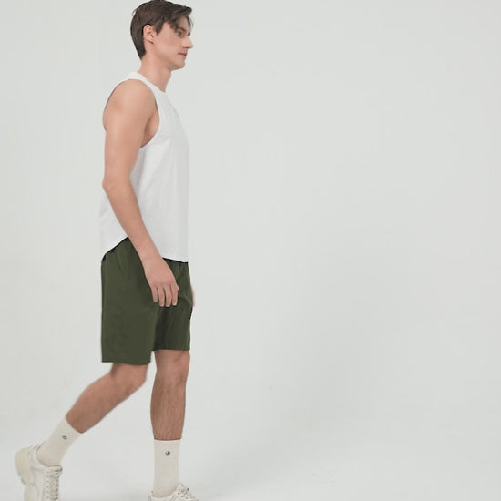 Amend Co. Male Model Wearing Sustainable White Tank Top and Green Shorts