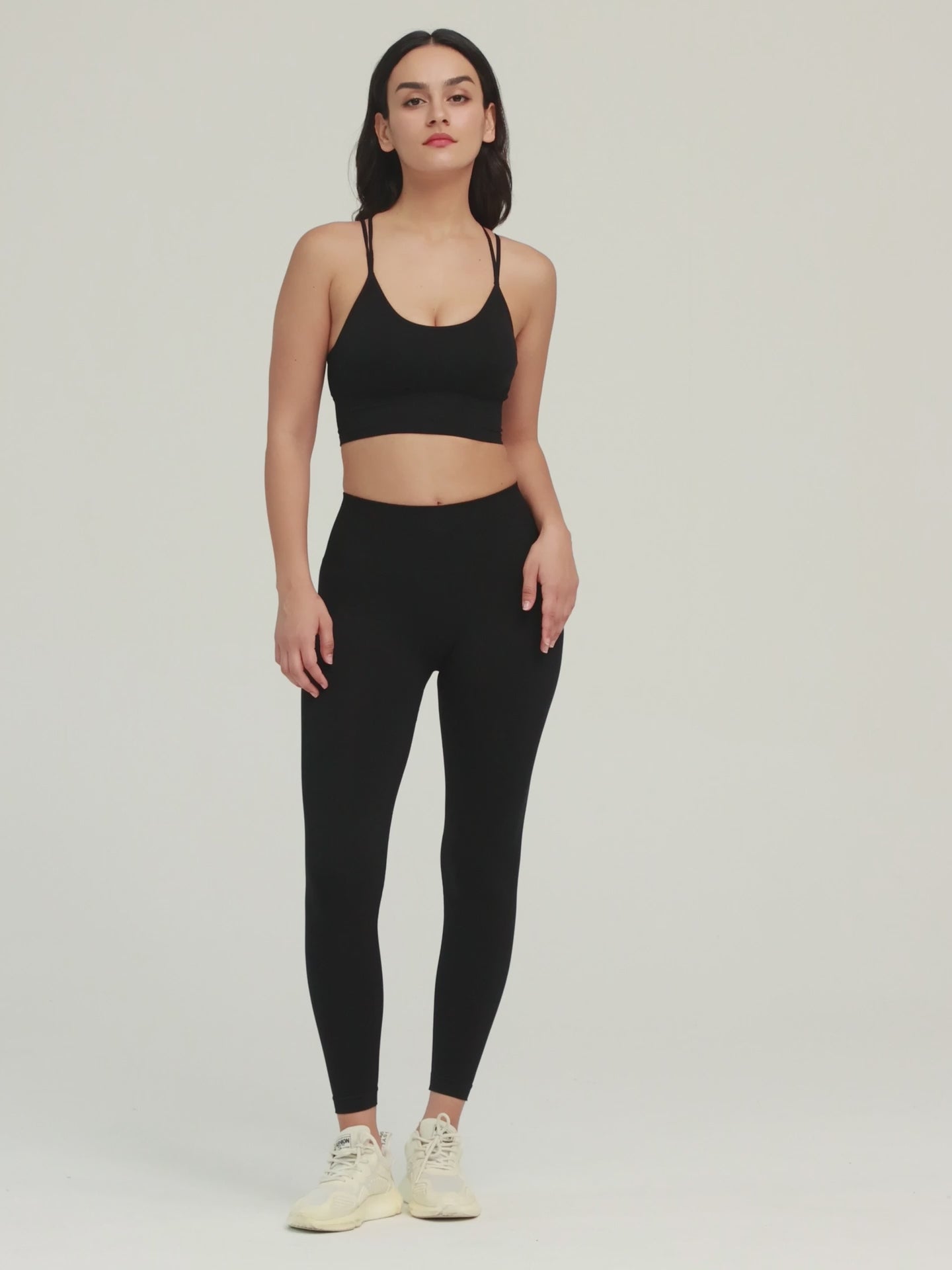 Amend Co. Female Model Wearing Eco-Friendly Black Bra and Black Leggings