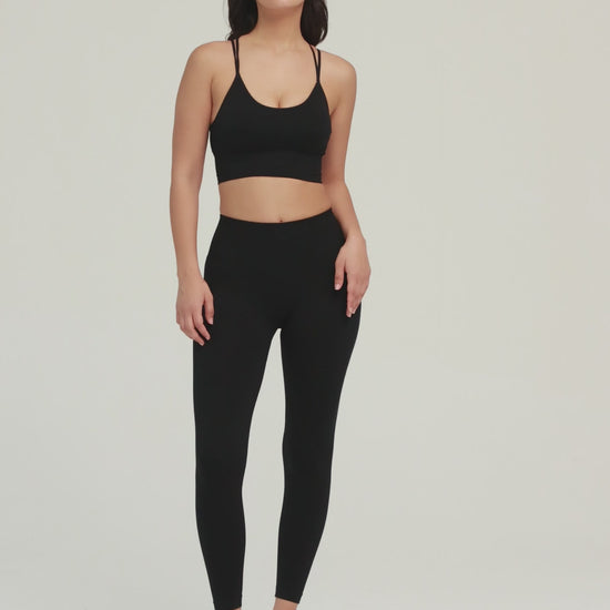 Amend Co. Female Model Wearing Eco-Friendly Black Bra and Black Leggings