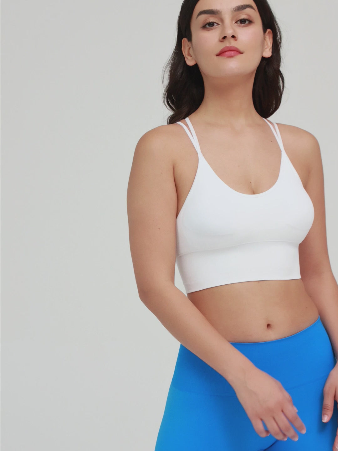 Amend Co. Female Model Wearing Eco-Friendly White Bra and Blue Leggings