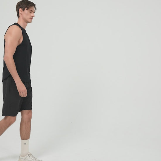 Amend Co. Male Model Wearing Sustainable Black Tank Top and Black Shorts