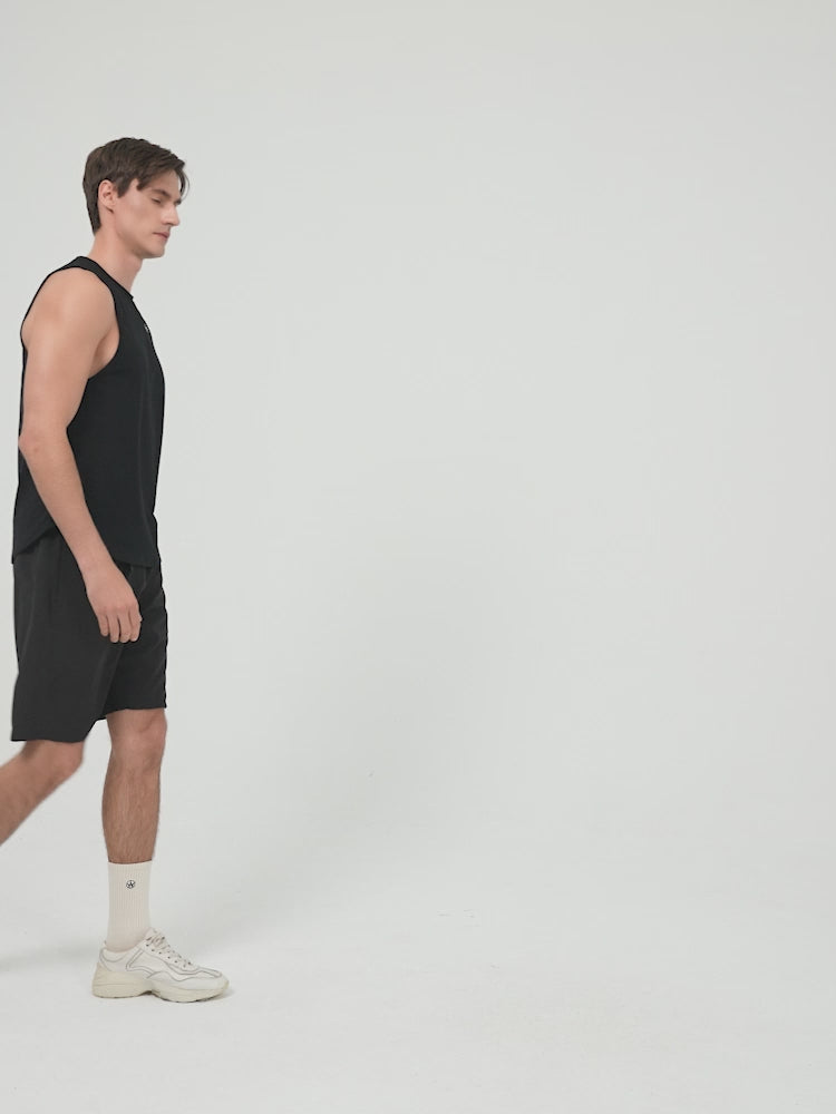 Amend Co. Male Model Wearing Sustainable Black Tank Top and Black Shorts